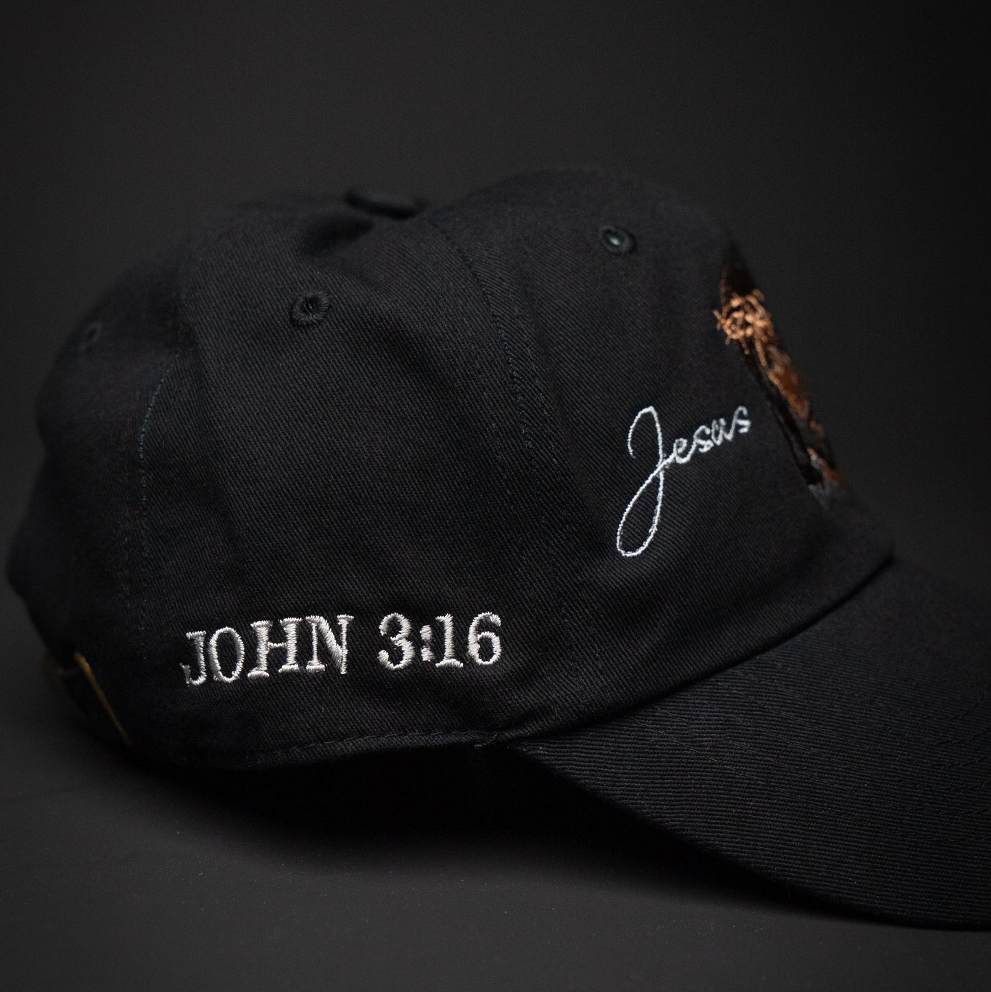 Black cap with 'John 3:16' and 'Jesus' embroidered on a dark background